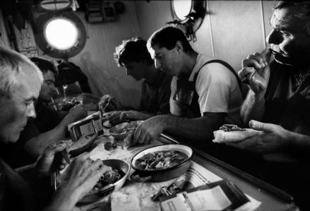 SPAIN. A crew of 16 work on board the tuna fishing boat. During the day each crew member helps to prepare meals. 1996.